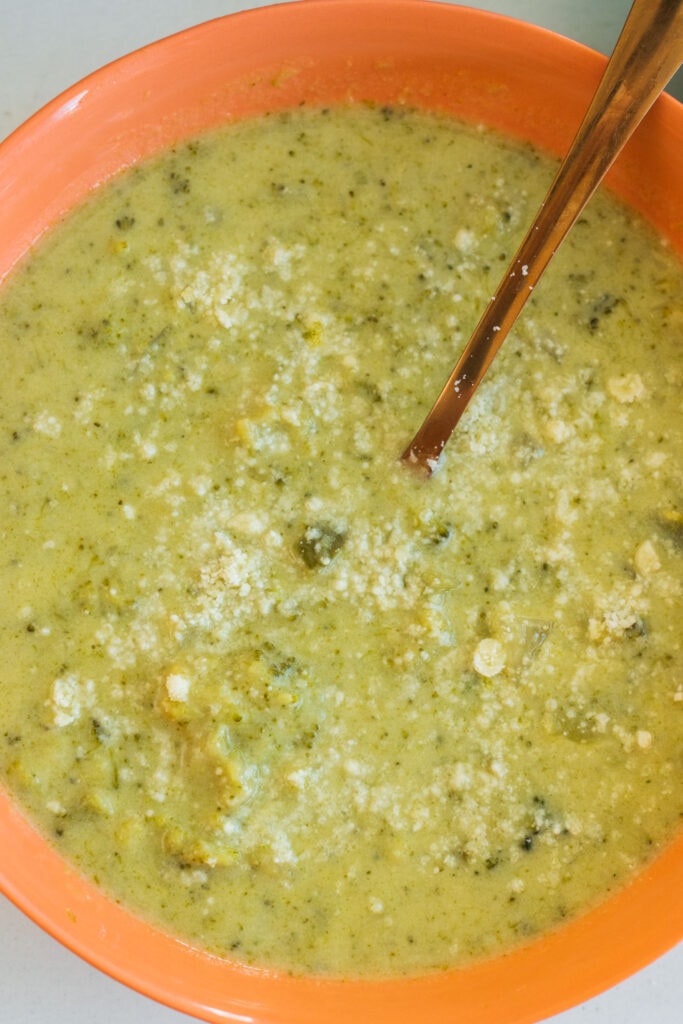 closeup of creamy broccoli soup with parmesan cheese on top.
