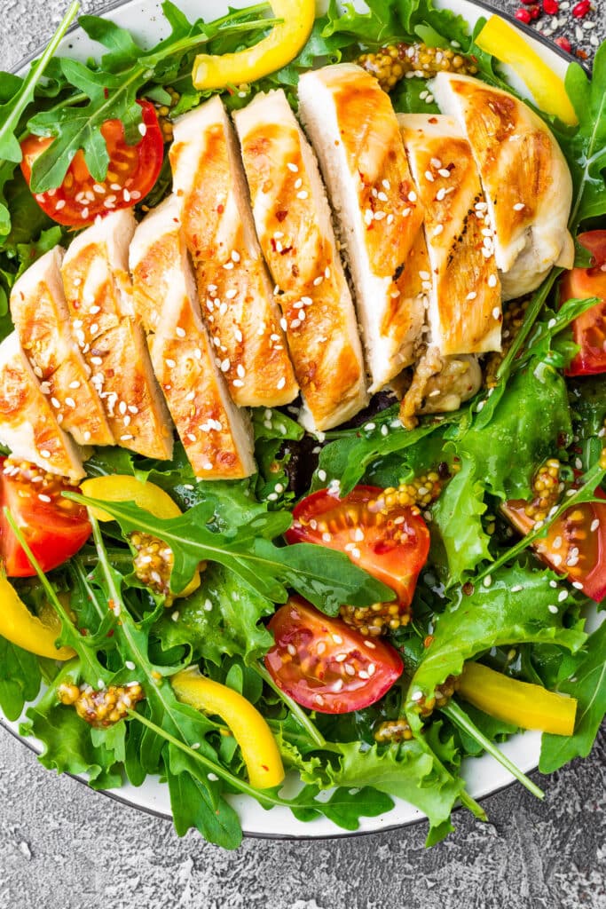 closeup of grilled chicken and greens.