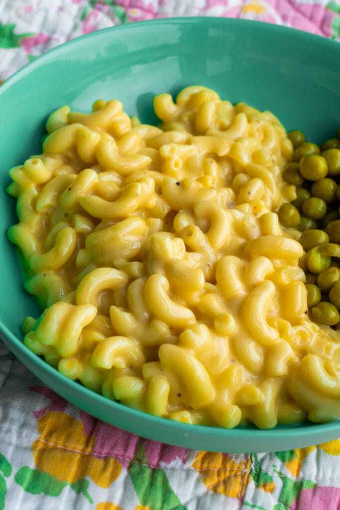 plate with mac and cheese and peas.