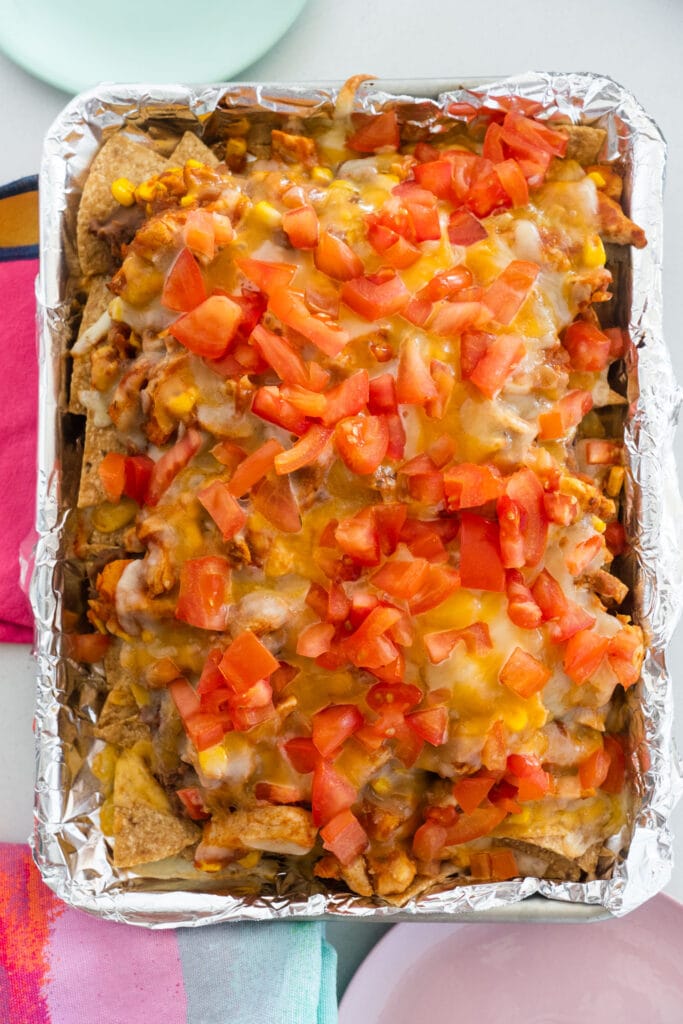 whole baking sheet filled with chicken nachos.