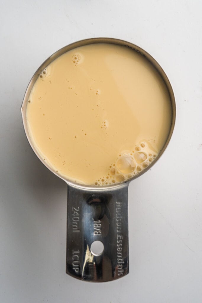 1 cup evaporated milk in measuring cup.