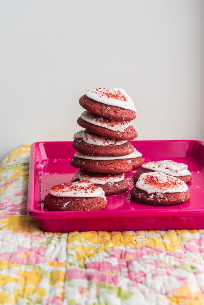 red velvet cookies on pink baking sheet.