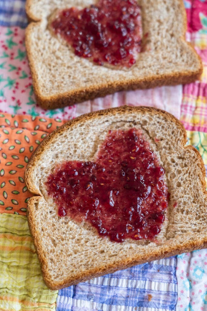 raspberry jam in the shape of heart on toast.