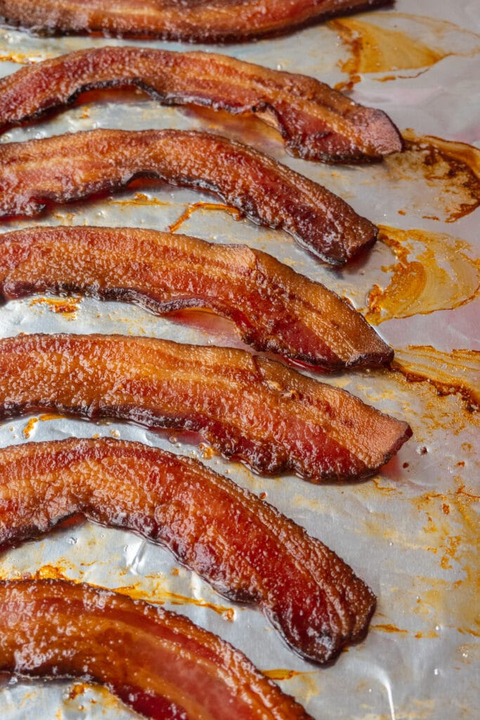 baked crispy bacon on aluminum foil covered baking sheet.