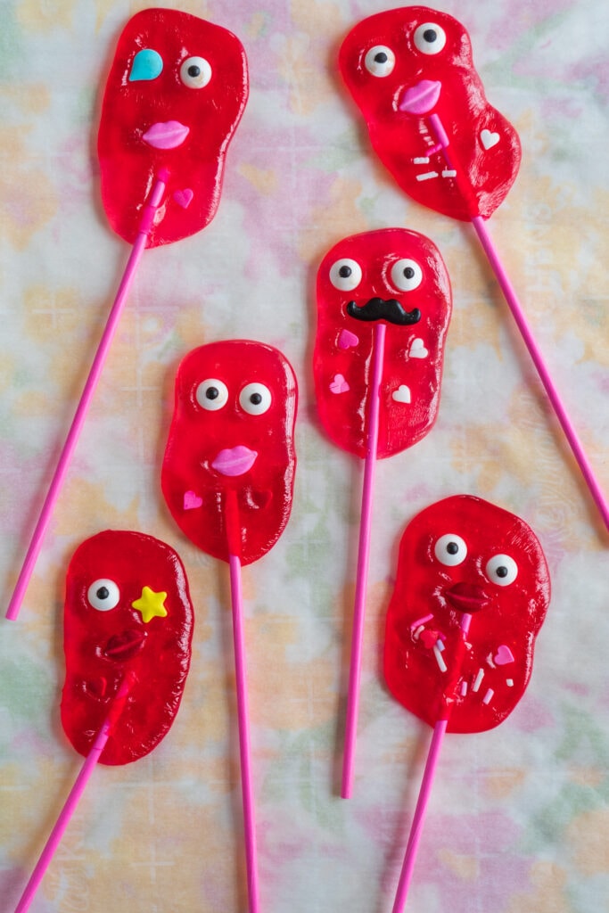 valentine monster lollipops on parchment paper.