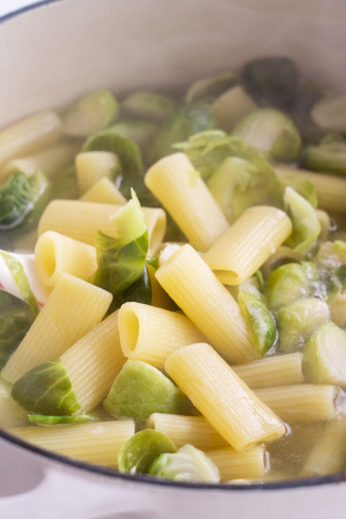 Brussels sprouts and pasta in pot boiling.