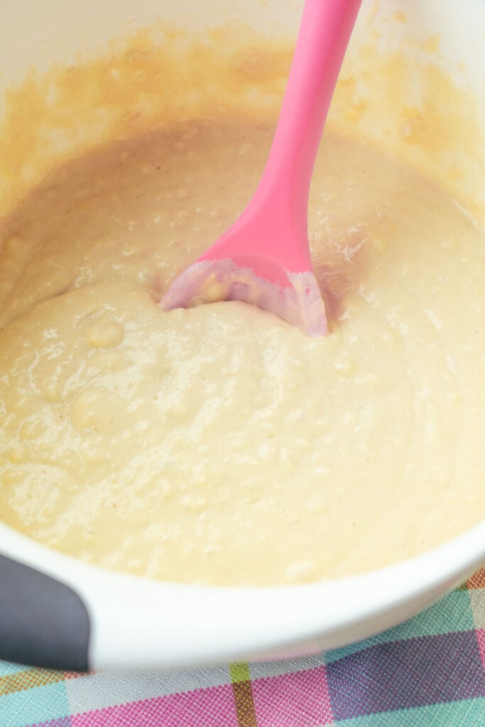 batter in white bowl with pink spoon.