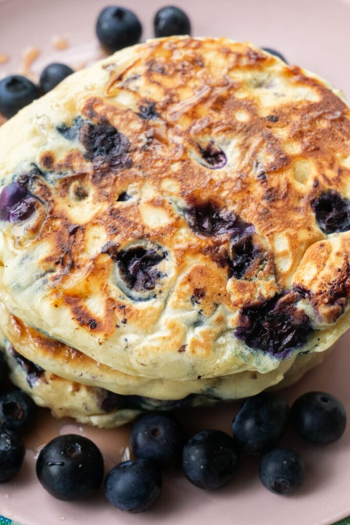 closeup of pancakes that are filled with blueberries in them.