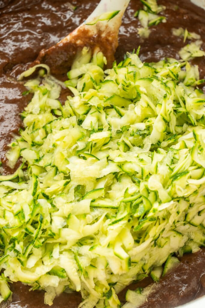 shredded zucchini in bowl with chocolate batter.