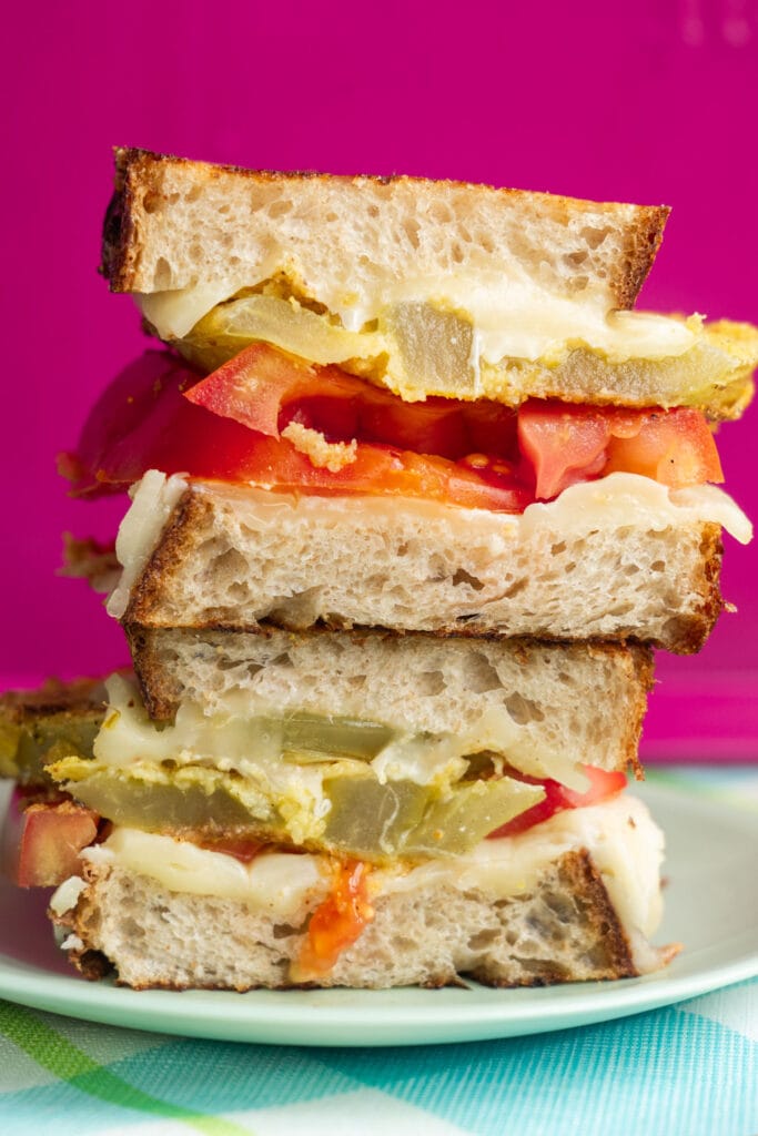 stack of fried green tomato sandwich with cheese.