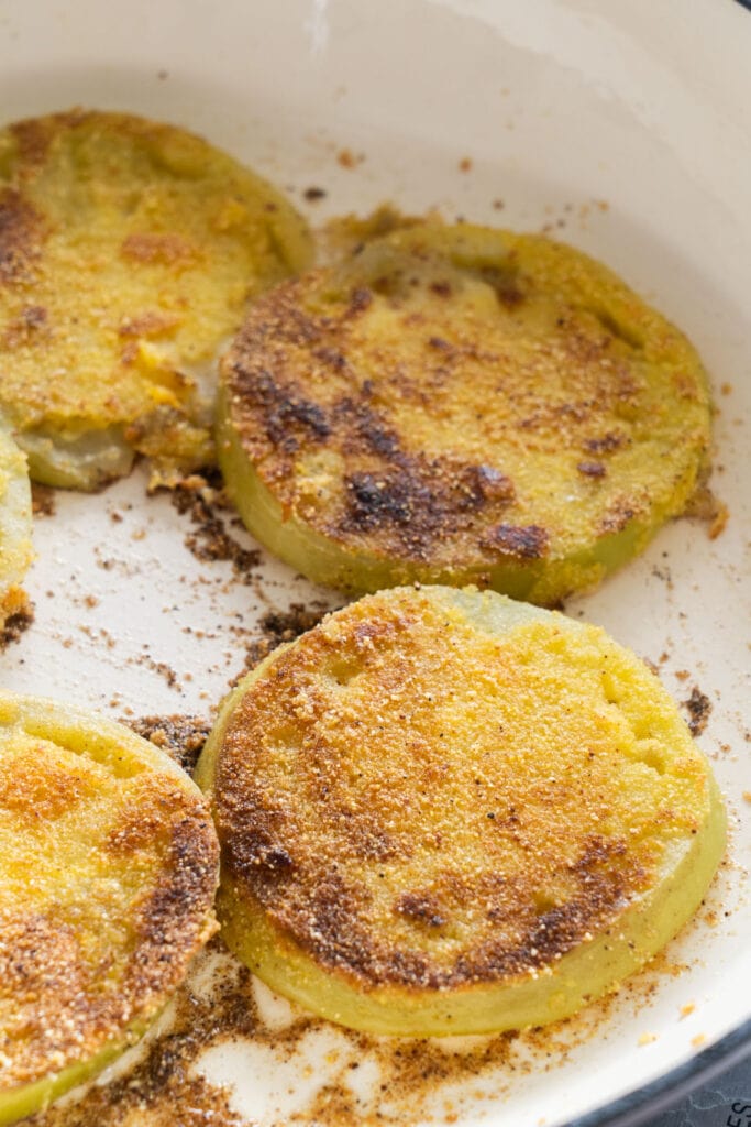 fried green tomatoes in skillet.