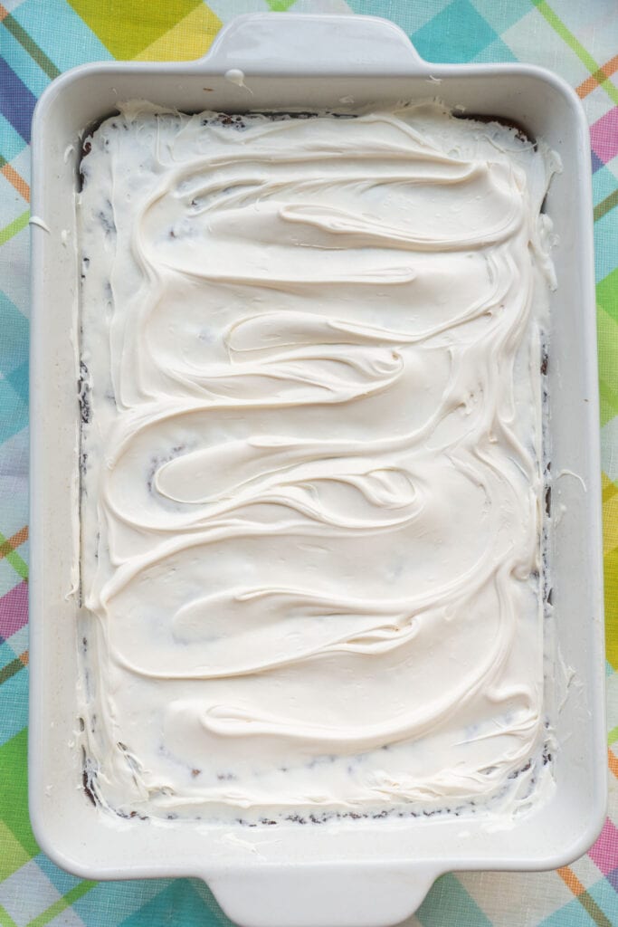 frosting spread on top of cake.
