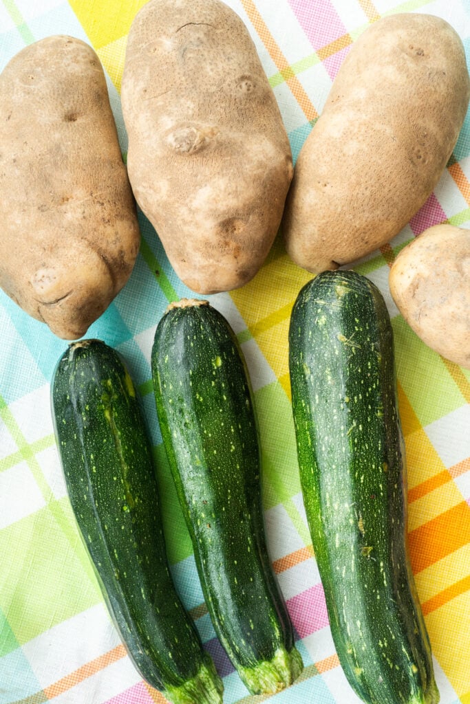 zucchini and potatoes on table.
