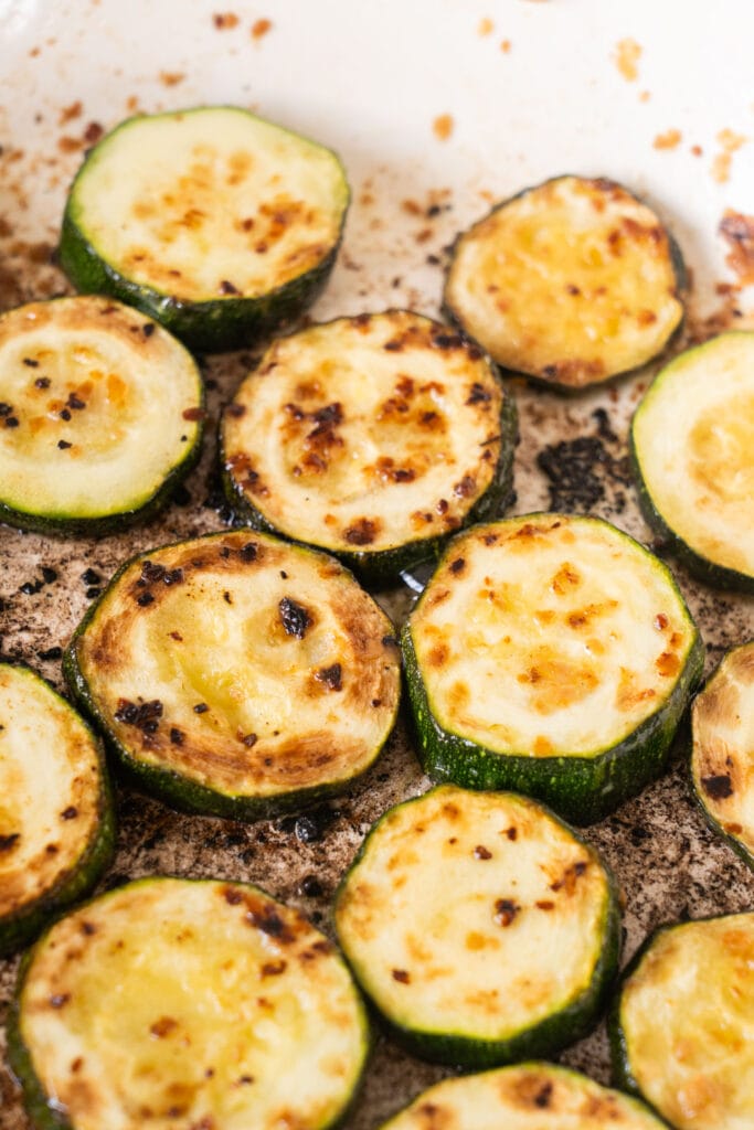 fried browned zucchini in skillet.