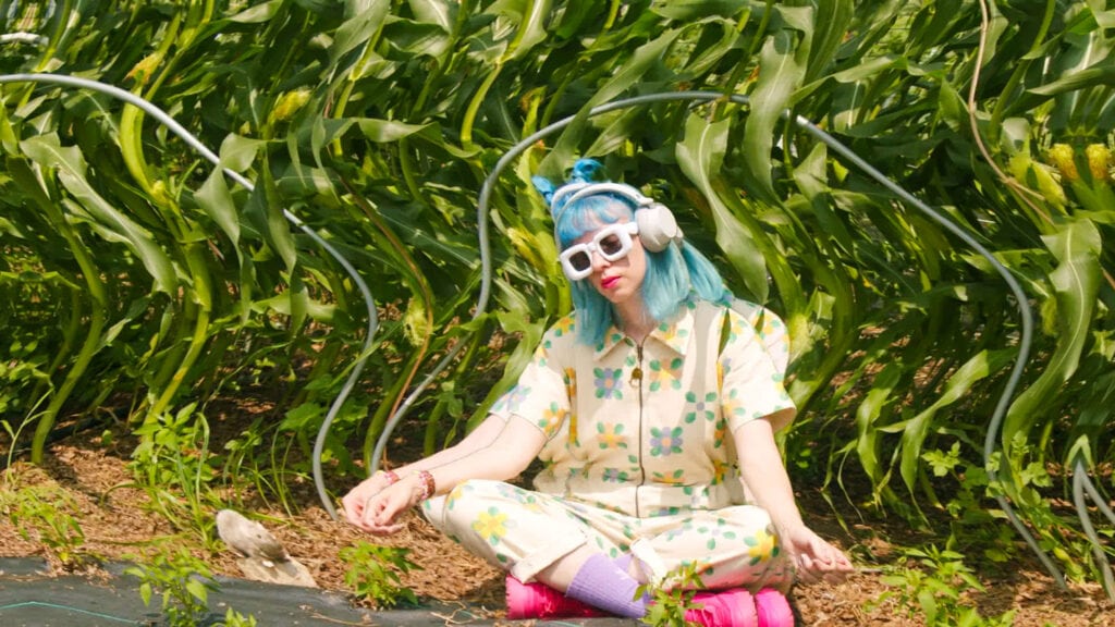 pamela with ultrasonic waves next to her in the garden.