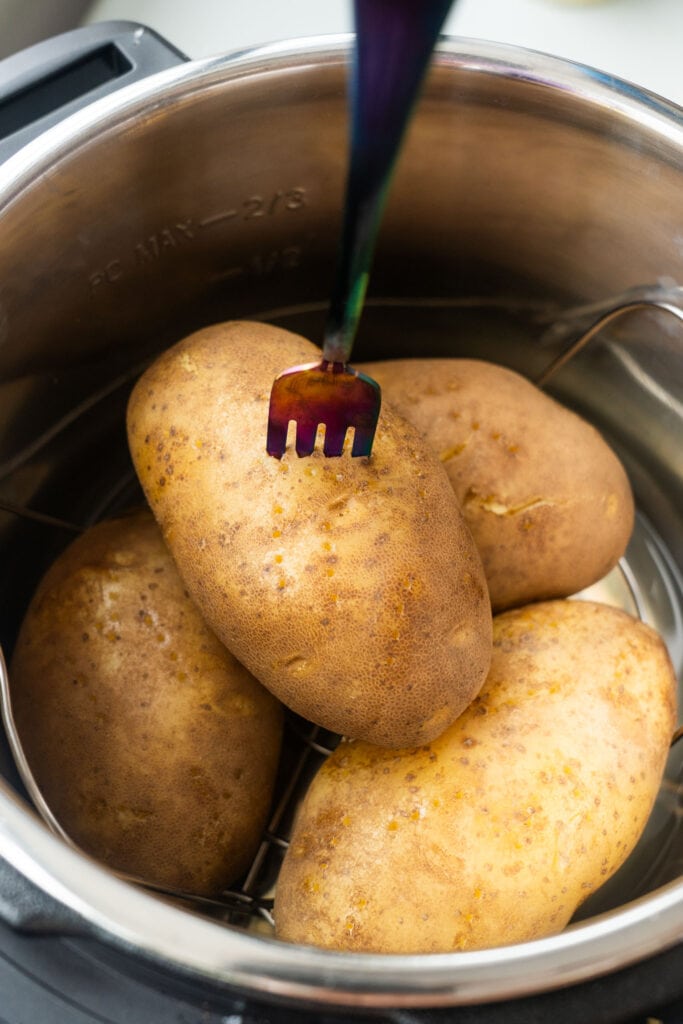fork sliding into baked potato in instant pot.