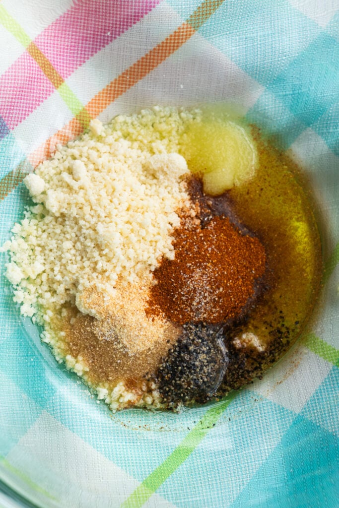 spices and parmesan cheese in bowl.