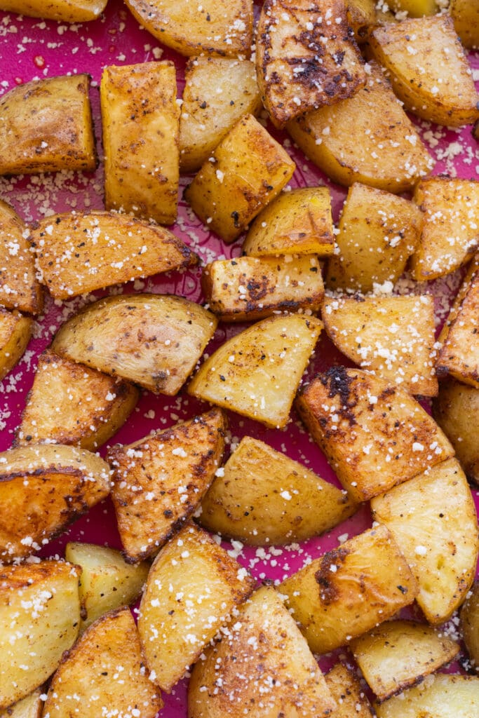 roasted potatoes coated in spices and parmesan cheese.