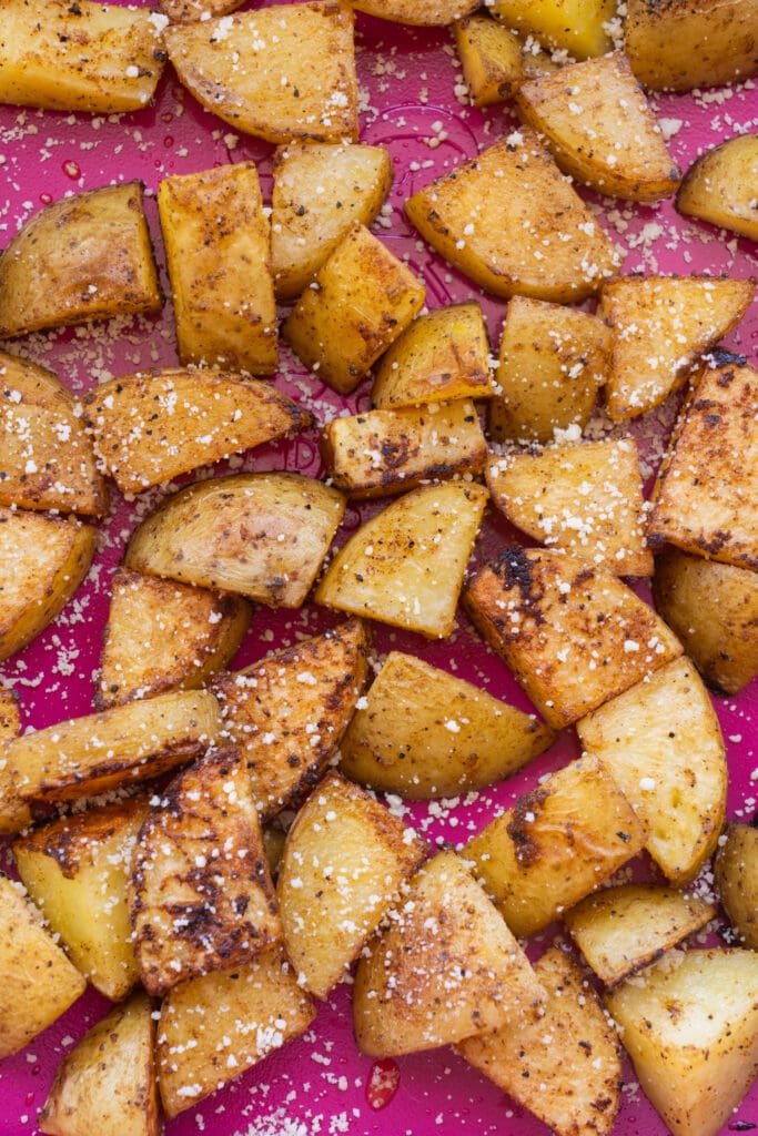 potatoes that are roasted with parmesan cheese sprinkled on top.