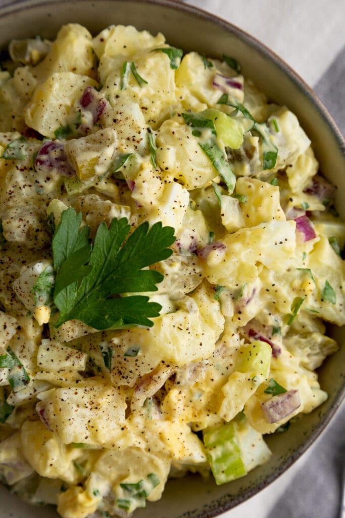 top down view of potato salad with red onions.
