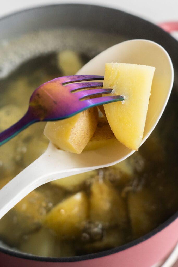 fork going through potatoes.