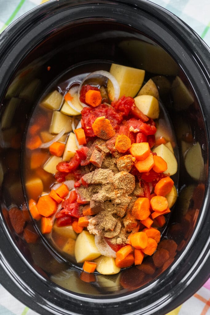 spices added into slow cooker.