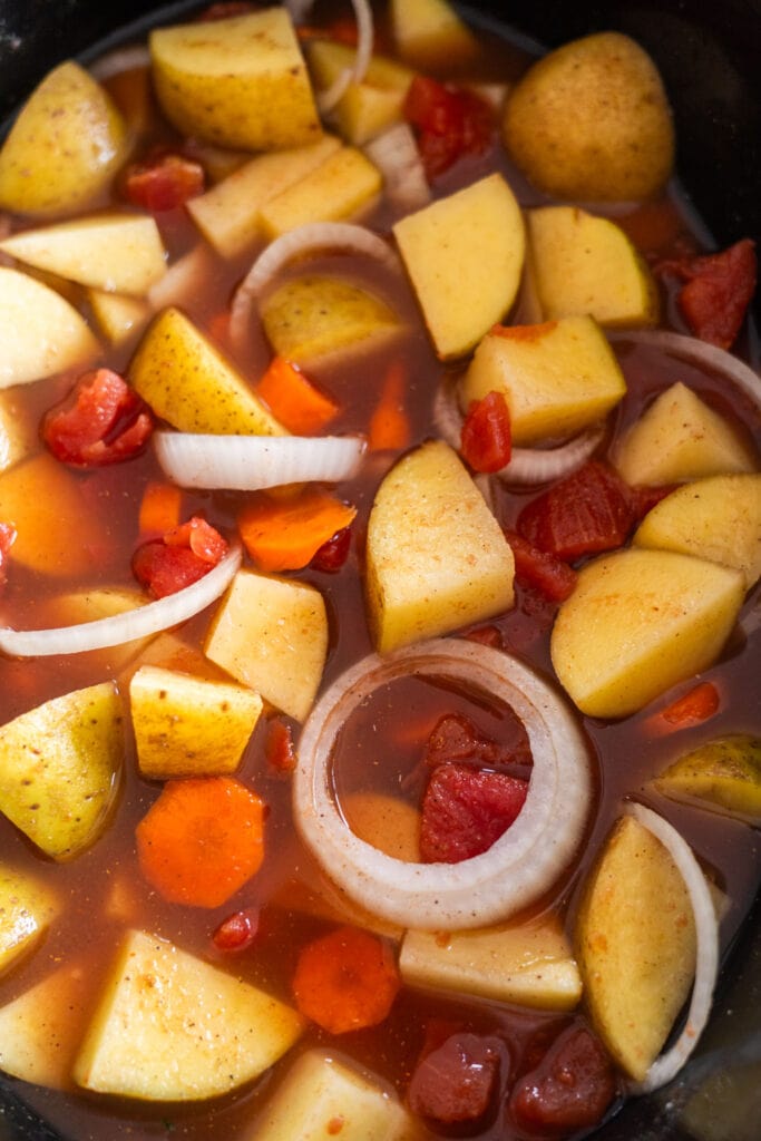 potatoes and vegetables in broth in slow cooker.