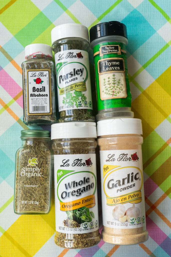spices on table that make italian seasoning.