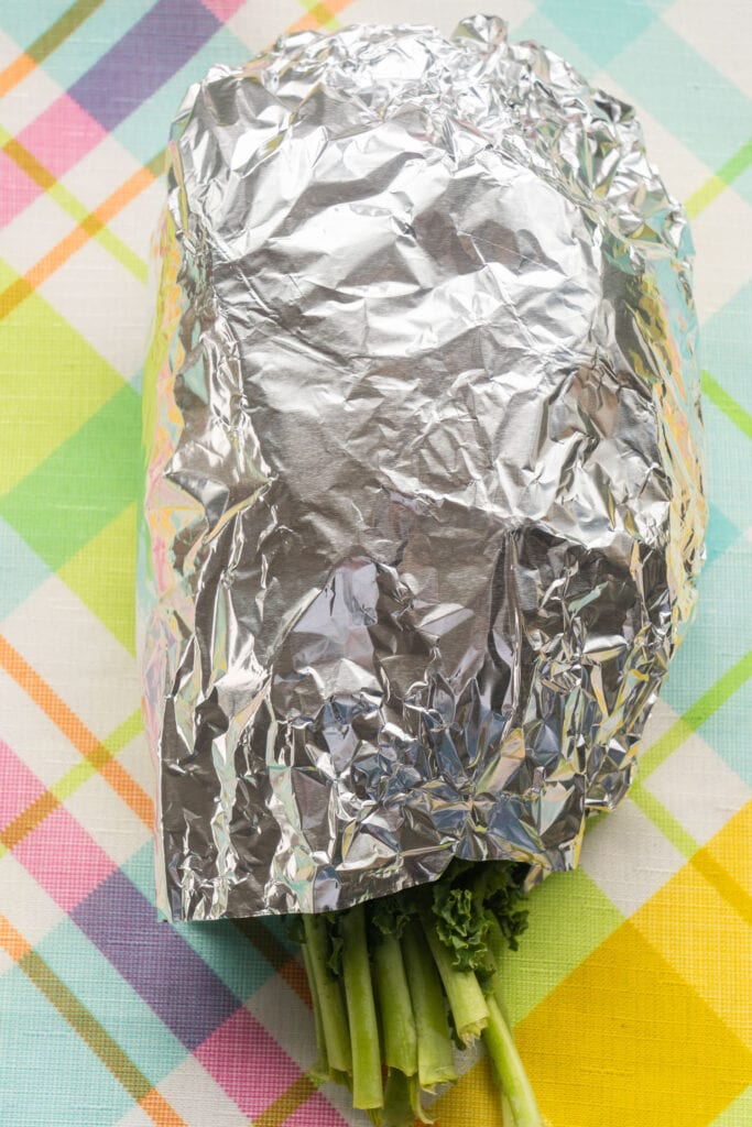 kale wrapped in aluminum foil half way. 