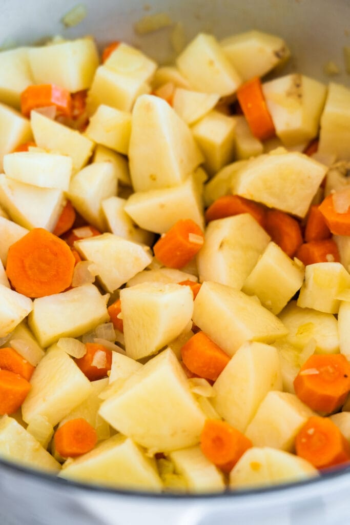 diced potatoes and carrots in pot.