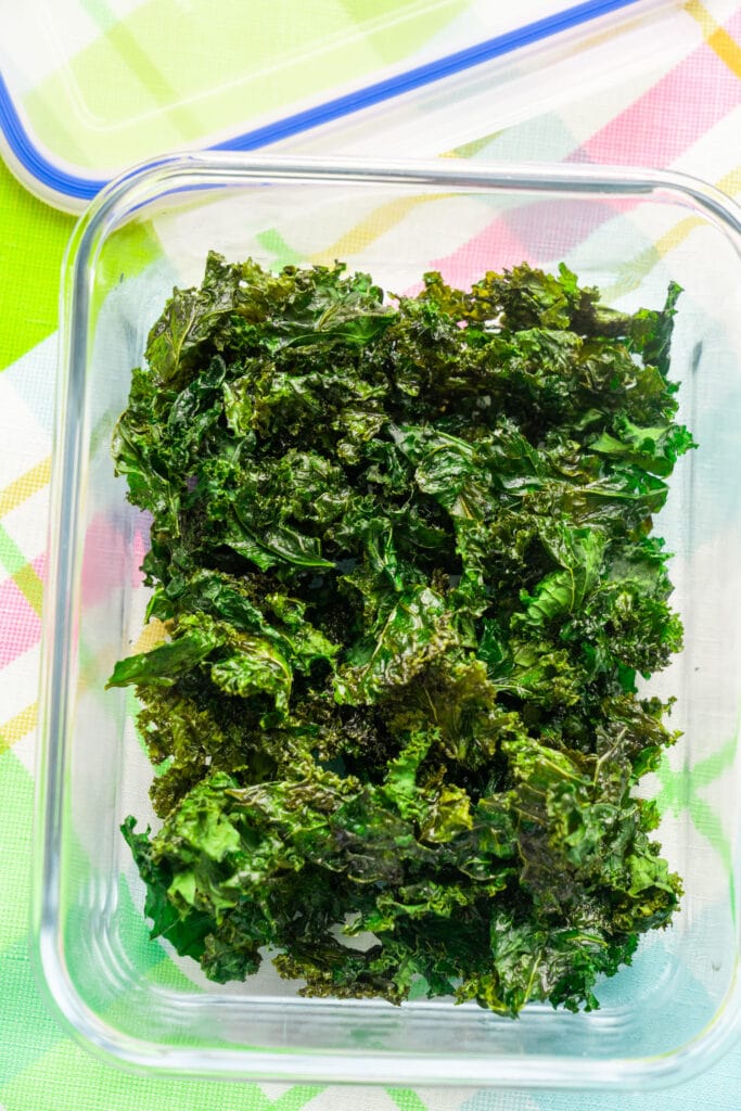 glass container storing kale chips in it.