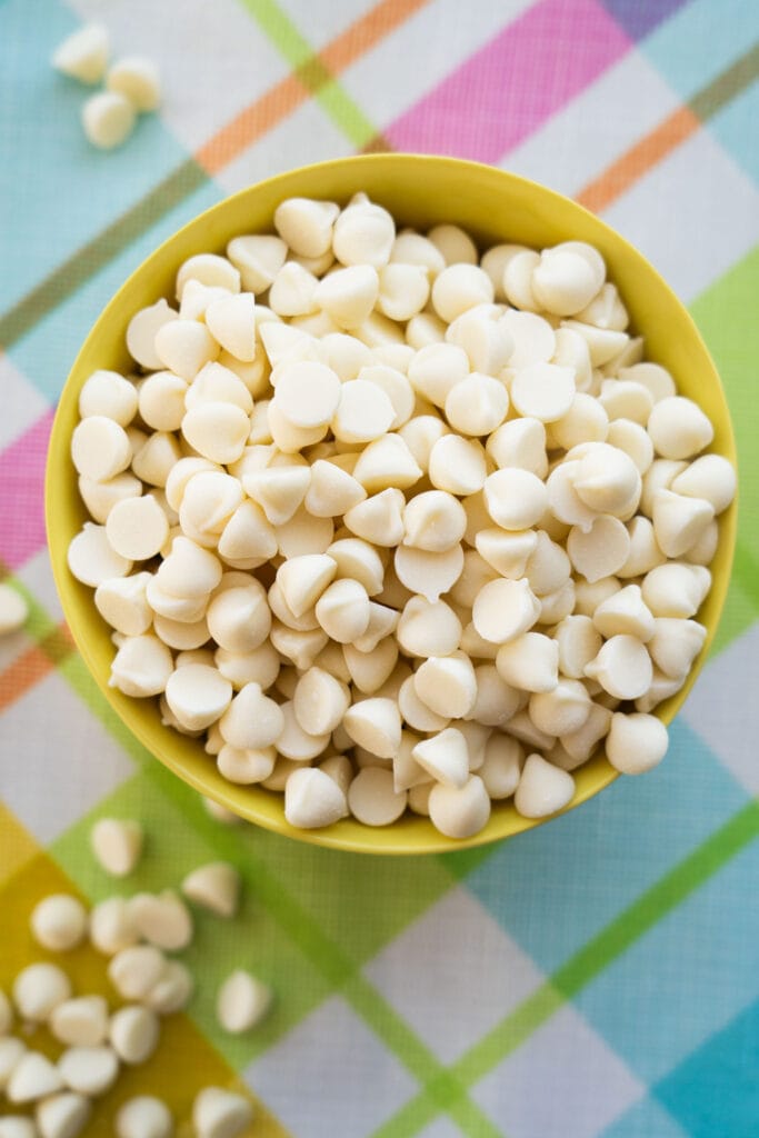 yellow bowl filled with white chocolate chips.