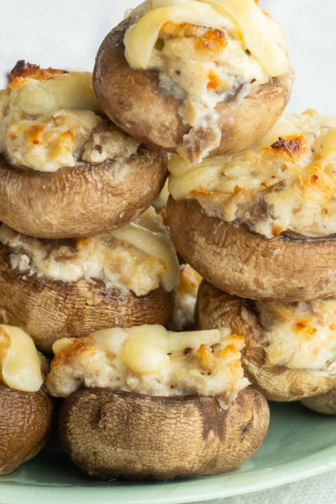 closeup of juicy stuffed mushrooms with cheese on top.