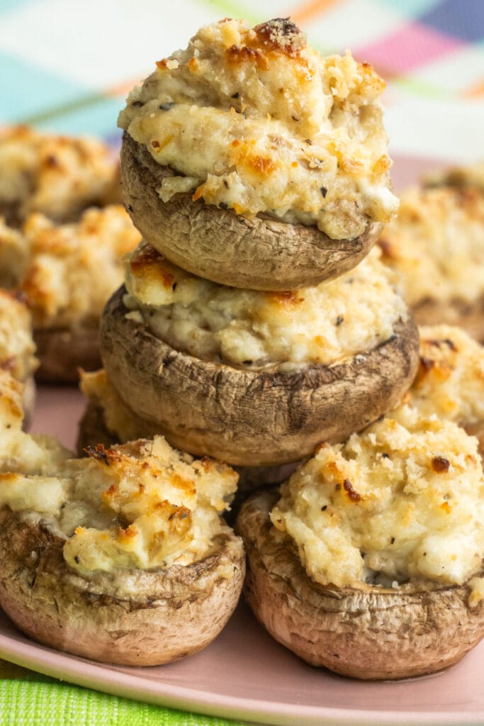 stuffed mushrooms stacked on top of each other on plate.