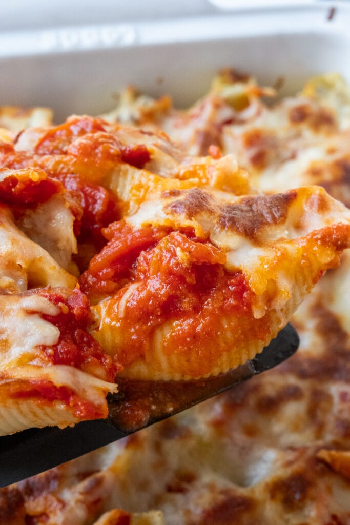 baked stuffed shells being served.