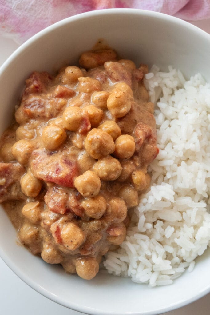 chickpea curry served in bowl with rice.