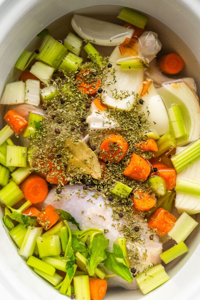chicken veggies and spices in crockpot.