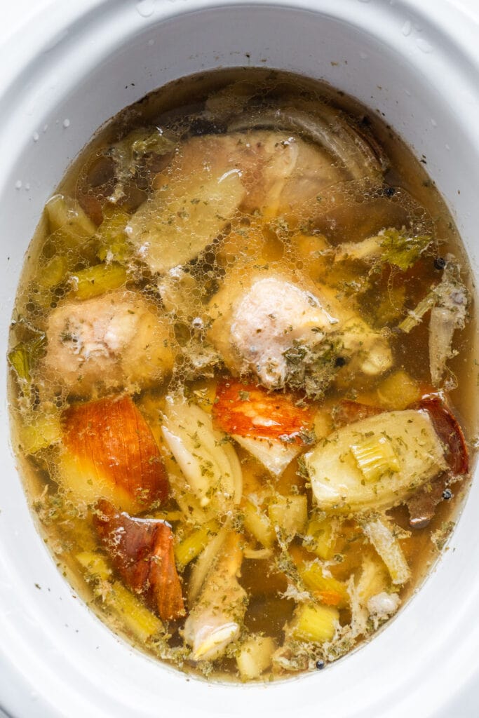 cooked chicken broth before being strained in slow cooker.