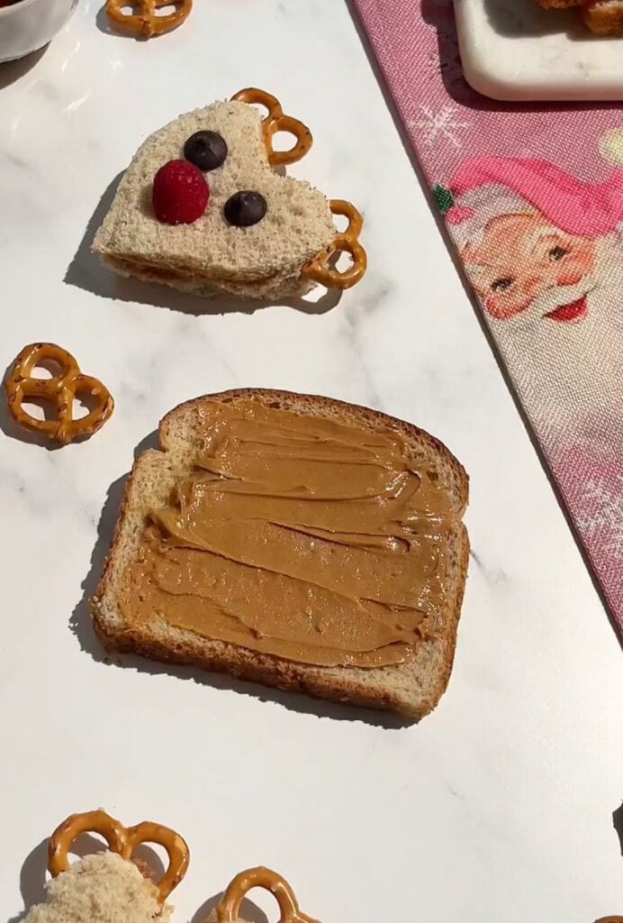 peanut butter added to slices of whole wheat bread.