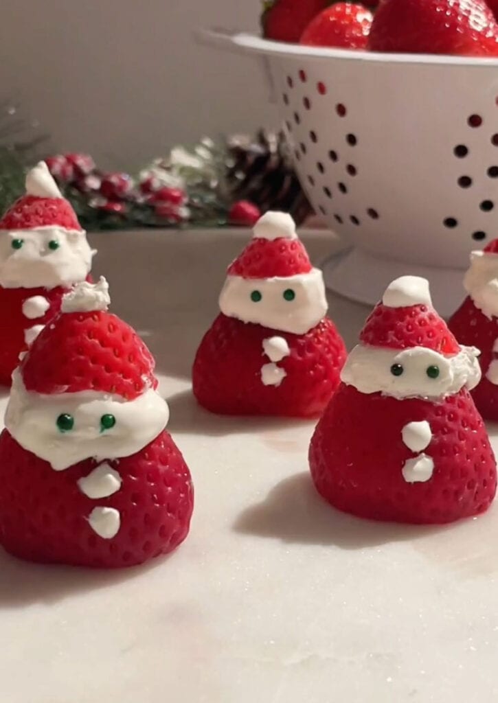 strawberry santas sitting on table.