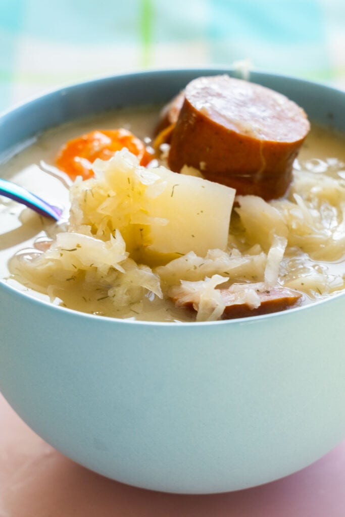 side view of bowl filled with sauerkraut soup.
