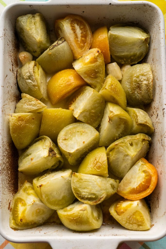 baked green tomatoes with garlic in baking dish.
