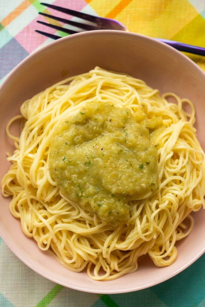 pasta with green tomato sauce on it.