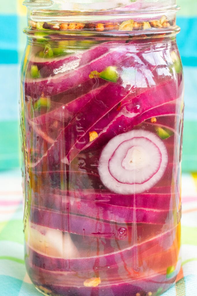 mason jar filled with pickled red onions.