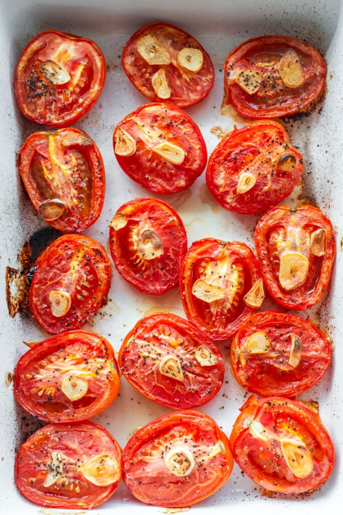 roasted roma tomatoes in baking dish.