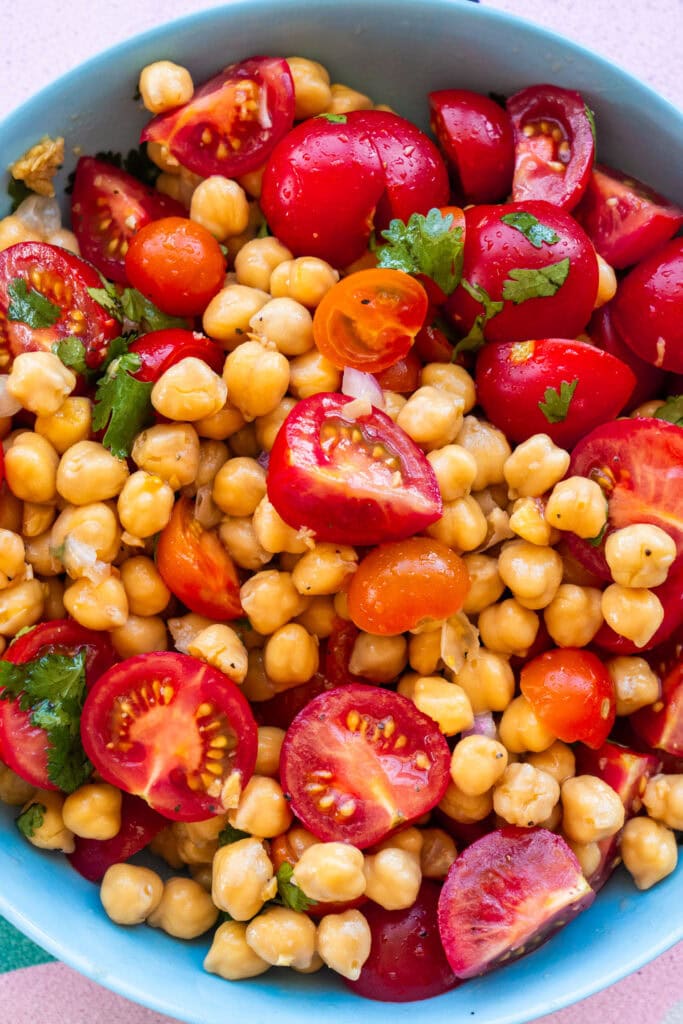 ingredients mixed together for tomato and chickpea salad.