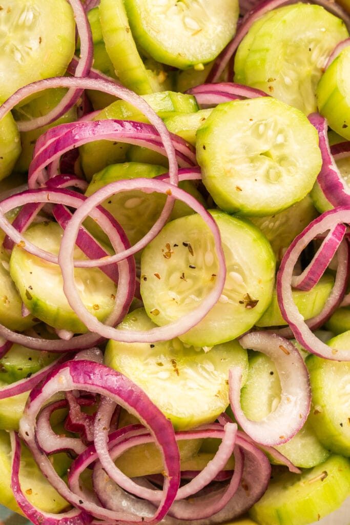 closeup of cucumber and red onion slices salad.