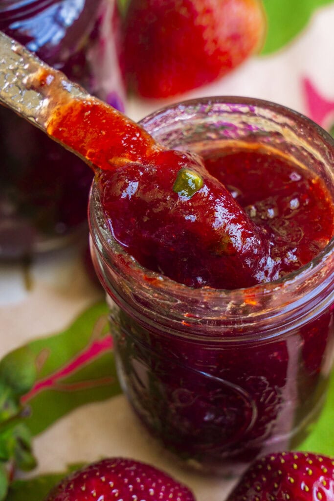 knife getting out strawberry jalapeno jam from mason jar.