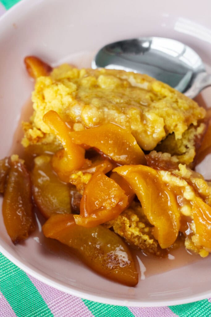 closeup of juicy soft peach cobbler. 