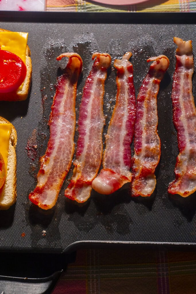 bacon cooking on griddle.